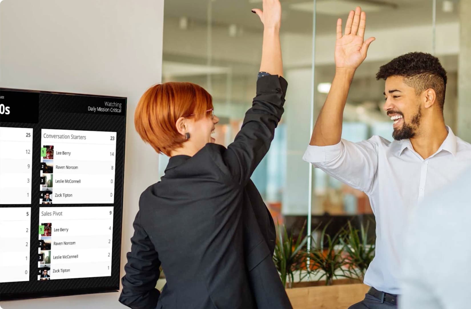 Two office workers giving a high five